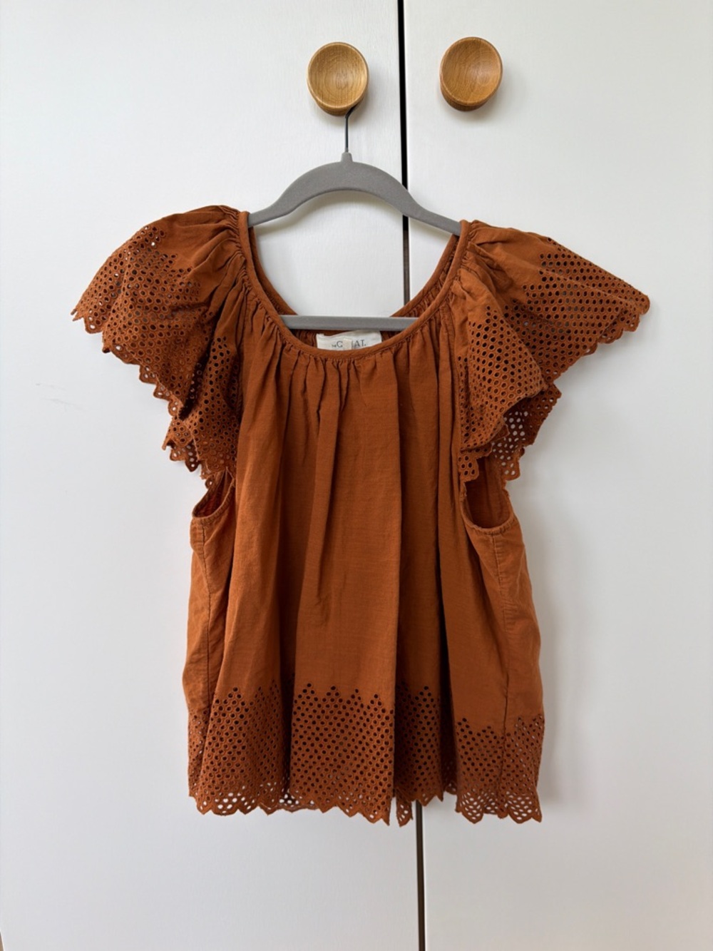THE GREAT. Eyelet Flutter Sleeve Top in Burnt Orange